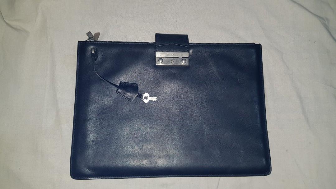 Authentic Versace Portfolio Clutch Bag (Category: Luxury Bags & Wallets) located in Manila. Submitted by snephysephy (Listing ID 1184245002, Image 1). Description: - This could fit a 14inch laptop. - Lock and zippers are functioning perfectly..