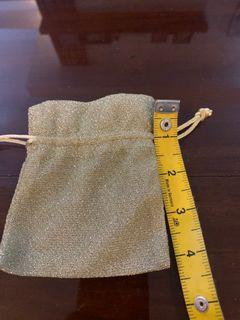Small gold shimmering jewelry pouch