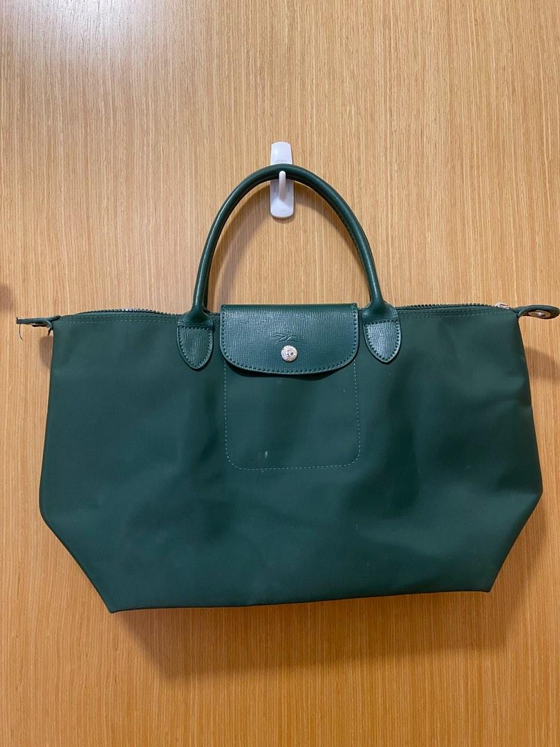 Longchamp Bag (Category: Bags & Wallets) located in Singapore. Submitted by lovelyclothesx (Listing ID 1185646744, Image 1). Description: Large size. Not sure about authenticity. Small dot on the front & the skin come off (2nd pic) Slightly nego .