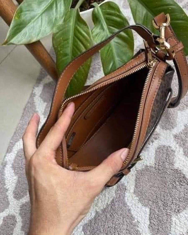 Michael Kors Emilia (Category: Luxury Bags & Wallets) located in Cavite. Submitted by LuxbyMarifrance (Listing ID 1186885201, Image 2). Description: 🏷 3,200 + SF 🛍 Michael Kors Emilia Half Moon Crossbody Small Saddle Bag Brown 📏 9”L x 8.5” H x 2.5” D 📌 with tag, care card, dust bag, paper bag ✨All trademarks, logos and brand names are the property of their respective owners. .