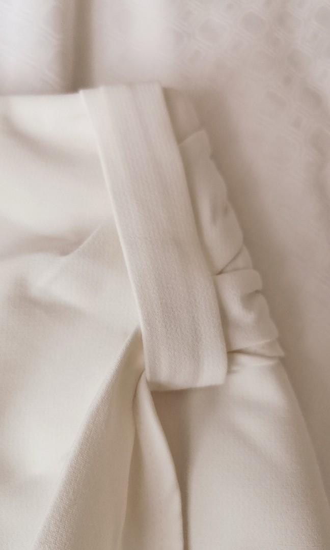 TCL white shorts (Category: Shorts) located in Singapore. Submitted by Lemon_Chamomile (Listing ID 1186928909, Image 3). Description: Looks like a skirt but it's a short. Polyester material, not see thru..