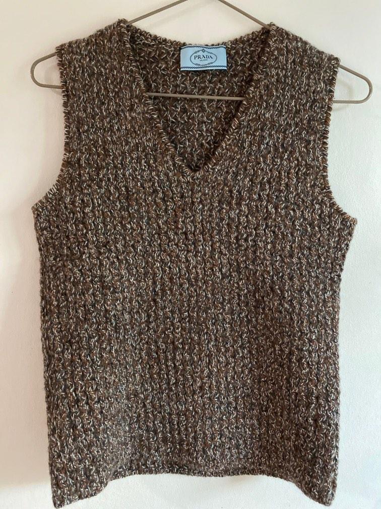 Authentic Prada vest (Category: Sleeveless) located in Singapore. Submitted by pristy102 (Listing ID 1187366299, Image 1). Description: Size 40 but really fits size 38 Pair with a white shirt for a funky but warm look Wool cashmere blend Never worn.