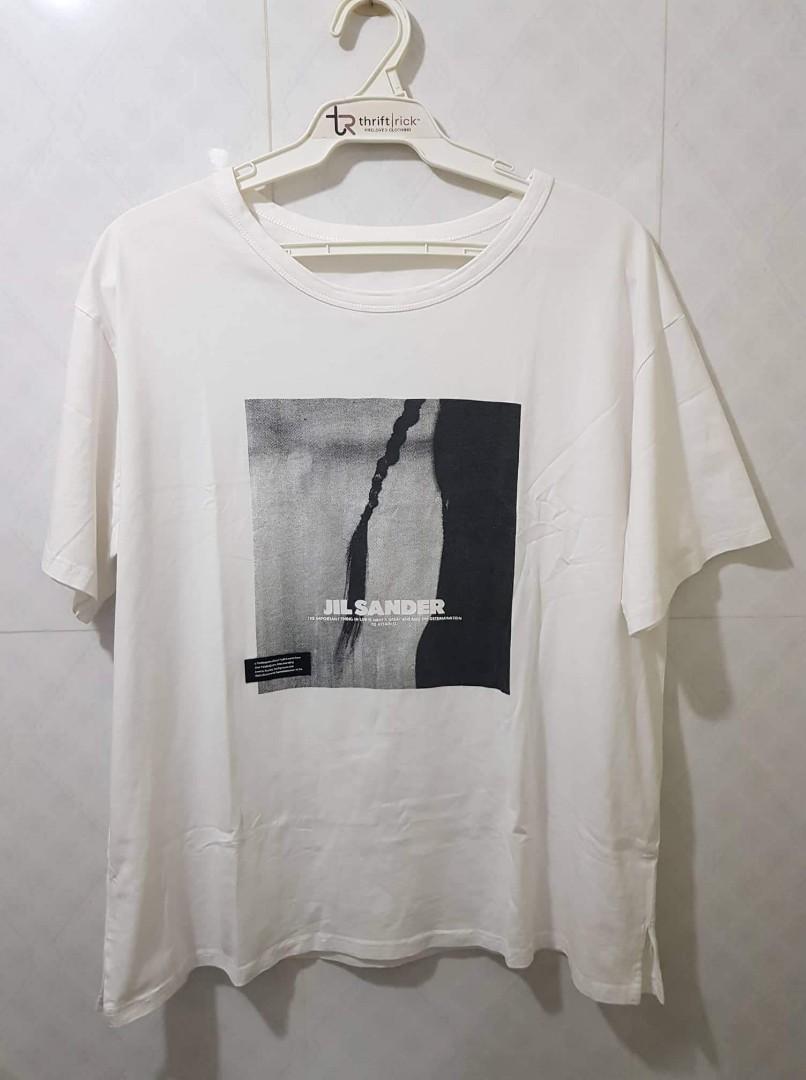 JIL SANDER × ESSENTIALS × CHOCO LADY WHITE PRINTED T-SHIRT (Category: Shirts) located in Indang. Submitted by thriftrick (Listing ID 1187282871, Image 3). Description: Size: Fits Medium-Semi Large Dimes: 22.5W ×26L Condition: Very Good Color Rate: 9.5/10 Issue: No necktag; Sign of usage l; needs wash Mode of Payment: Gcash Shipping: Shopee checkout (preferred by the seller) Strictly payment first policy Price: Php 650+ sf PLS. READ THIS 1. Paymen
