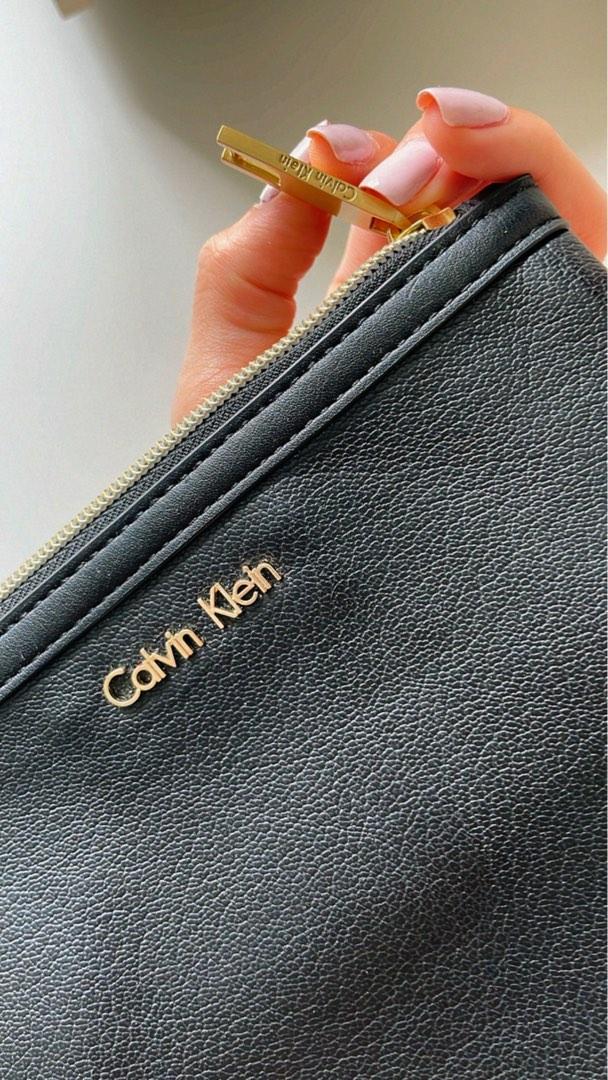 Calvin Klein Jeans monogram logo wristlet purse in cream | ASOS