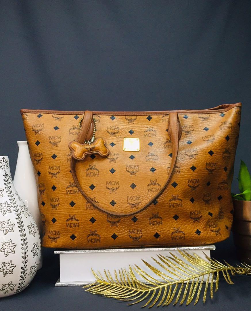 MCM Dogbone Tote (Category: Luxury Bags & Wallets) located in Baguio. Submitted by BagstacularbyJCT (Listing ID 1182598469, Image 1). Description: MCM Tote in Cognac Visettos. With dogbone charm. Details in pics. .
