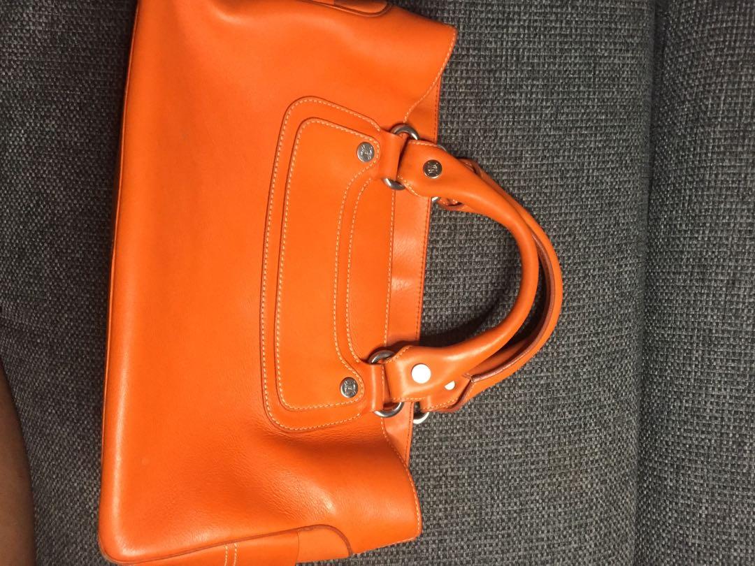 Celine Boogie Bag (Category: Luxury Bags & Wallets) located in Baguio. Submitted by BagstacularbyJCT (Listing ID 1182892341, Image 2). Description: Celine leather shoulderbag in orange colorway. Clean exterior and interior. Open top Three interior compartments. Middle compartment has zip closure. Slip pocket in interior. Minimal signs of use except for an undone stitch in one of the pockets. Size/Measurements (approx.) 12.5" length 5.5" depth 7.5