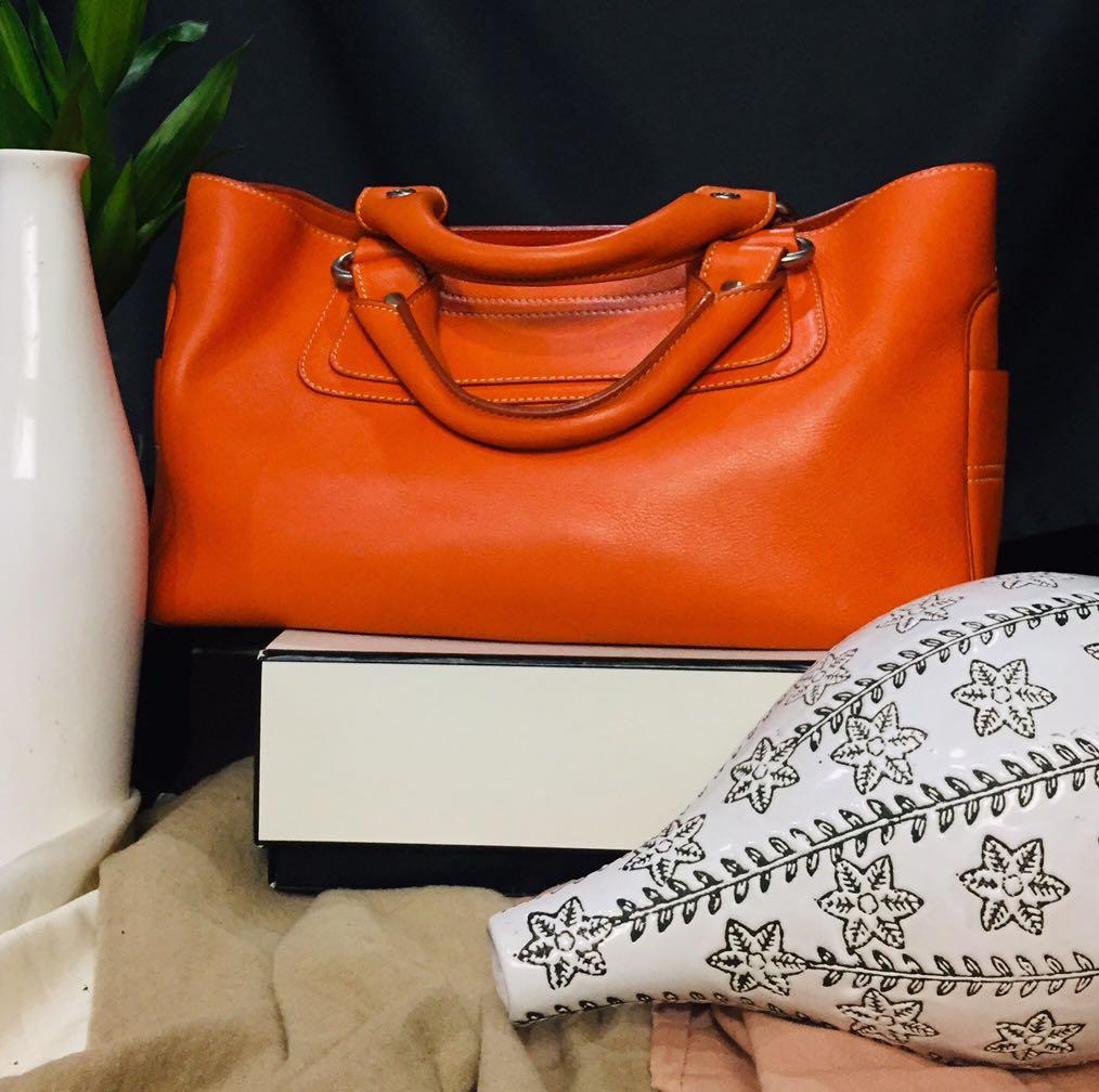 Celine Boogie Bag (Category: Luxury Bags & Wallets) located in Baguio. Submitted by BagstacularbyJCT (Listing ID 1182892341, Image 1). Description: Celine leather shoulderbag in orange colorway. Clean exterior and interior. Open top Three interior compartments. Middle compartment has zip closure. Slip pocket in interior. Minimal signs of use except for an undone stitch in one of the pockets. Size/Measurements (approx.) 12.5" length 5.5" depth 7.5