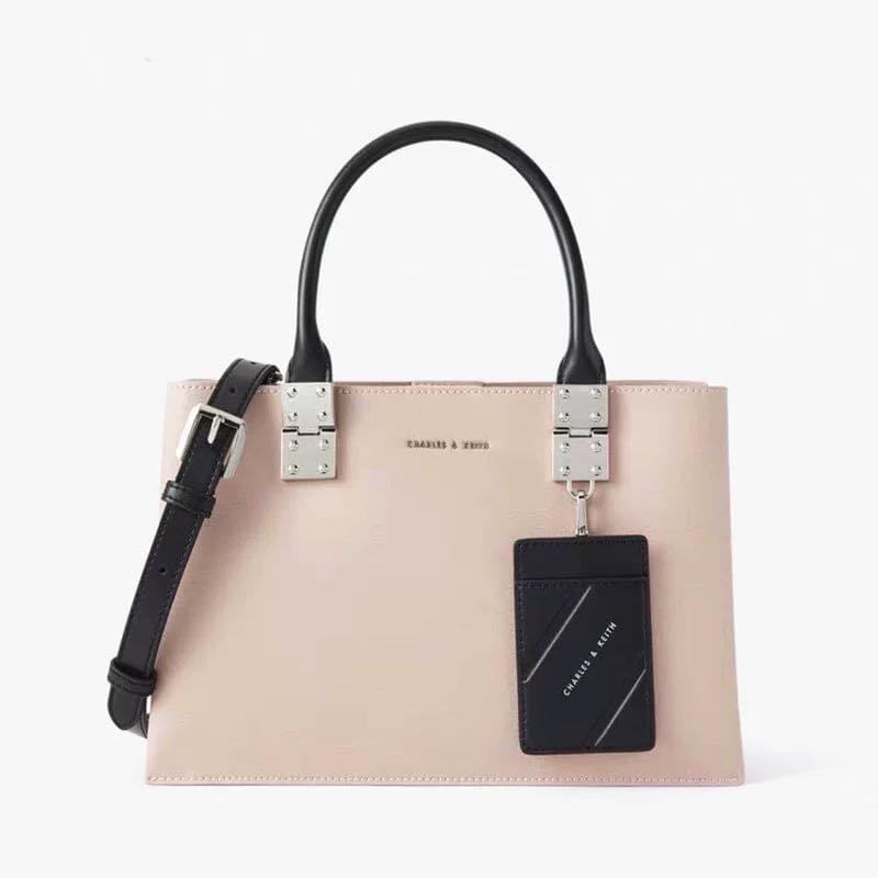Charles & Keith Double Top Handle Structured Crossbody (Category: Cross-body Bags) located in Manila. Submitted by chic.collectivemnl (Listing ID 1182826365, Image 3). Description: Charles & Keith Double Top Handle Structured Crossbody Size: 30x12x18cm Colors: ultra black, light pink Price: 1,250 only!.