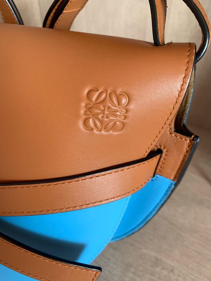Authentic Loewe Gate Two Tone Small Bag (Category: Luxury Bags & Wallets) located in Quezon City. Submitted by breakmyfashion (Listing ID 1183216034, Image 2). Description: Condition is overall very good with some signs of use. Comes with cards, tags, dust bag and receipt. Color: Tan and Sky Blue Material: Calf Leather Dimensions: Depth: 8.5 cm Height: 18 cm Strap: 48 cm (adjustable) Width: 25.5 cm.