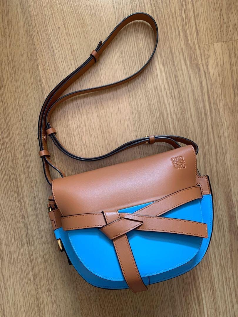 Authentic Loewe Gate Two Tone Small Bag (Category: Luxury Bags & Wallets) located in Quezon City. Submitted by breakmyfashion (Listing ID 1183216034, Image 1). Description: Condition is overall very good with some signs of use. Comes with cards, tags, dust bag and receipt. Color: Tan and Sky Blue Material: Calf Leather Dimensions: Depth: 8.5 cm Height: 18 cm Strap: 48 cm (adjustable) Width: 25.5 cm.