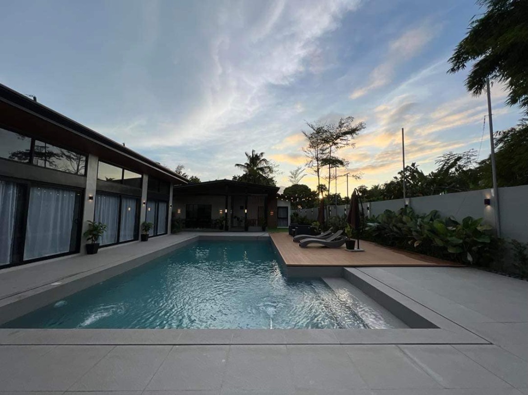 Luxury private pool villa with outdoor seating and garden area