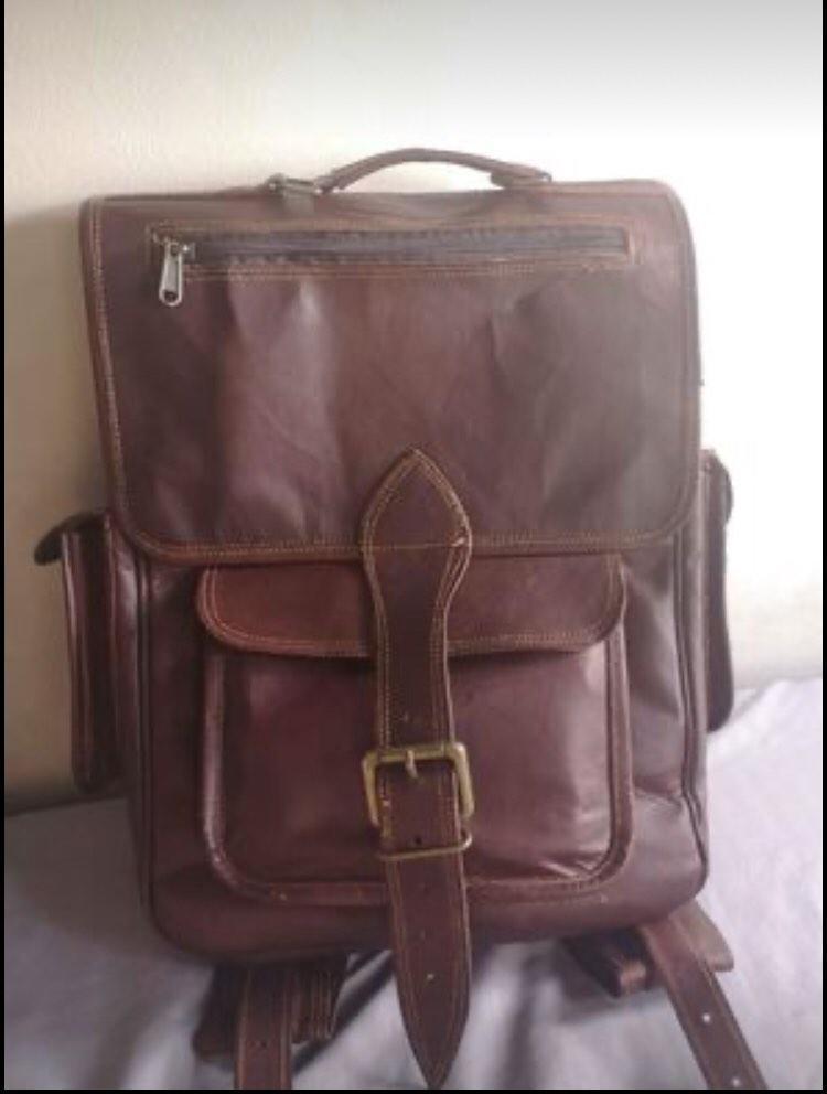 Authentic Genuine Leather Backpack (Category: Backpacks) located in Manila. Submitted by officialtheia (Listing ID 1183765344, Image 1). Description: Authentic Genuine Leather Backpack (UNISEX) BRANDNEW from Saudi P 3,000 2 side pockets 4 zipper pocket 2 Big compartment inside 2 front pocket Good for travelling! Dimensions: Length: 12inches Width: 4 inches Height: 15 inches Small laptop/Ipad can fit flaw: slit (last pic.) (already there when boug