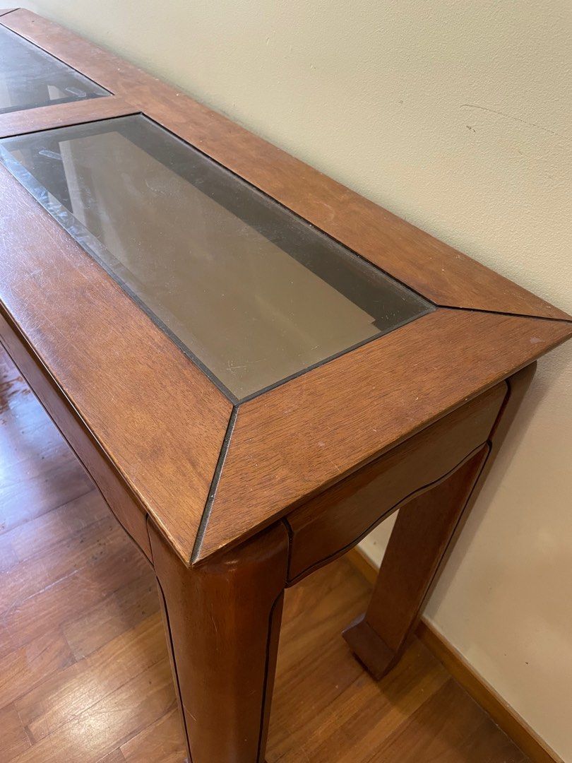 Console table (Category: Tables & Sets) located in Singapore. Submitted by m.poppins (Listing ID 1209695587, Image 3). Description: Side table - glass top / wood frame. Width 137cm, depth 39.5cm, height 67cm. Self pick up at Upper Thomson Road. .