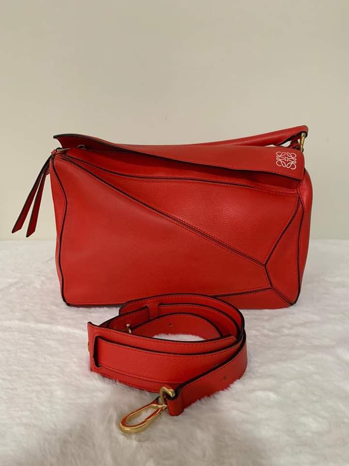 Loewe Puzzle Medium Bag (Category: Luxury Bags & Wallets) located in Manila. Submitted by bagislifeshop (Listing ID 1210207614, Image 1). Description: ▪️Loewe Puzzle Medium Bag▪️ ☑️Available in Pampanga ✅Condition: 8.8/10 ✅Dimensions: 28.5 x 17.5 X 12 cm ✅Colour: Red calfskin ✅Inclusion: Replacement dustbag and strap.
