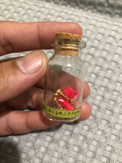 Small hear shaped clip on earrings in a small bottle jar