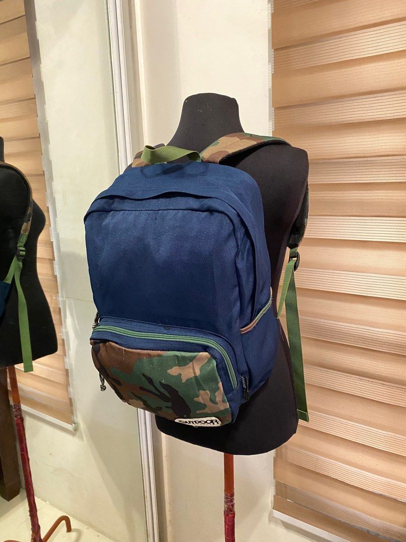 Outdoor Backpack (Category: Backpacks) located in Quezon City. Submitted by prelovedbagsbygiv (Listing ID 1207110285, Image 1). Description: Brand: Outdoor Products Bag type: Backpack Color: blue and camo Material: Nylon Size: Height: 15 in. Length: 11 in. Width: 5 in. In good condition Zipper closure Minimal sign of usage inside .