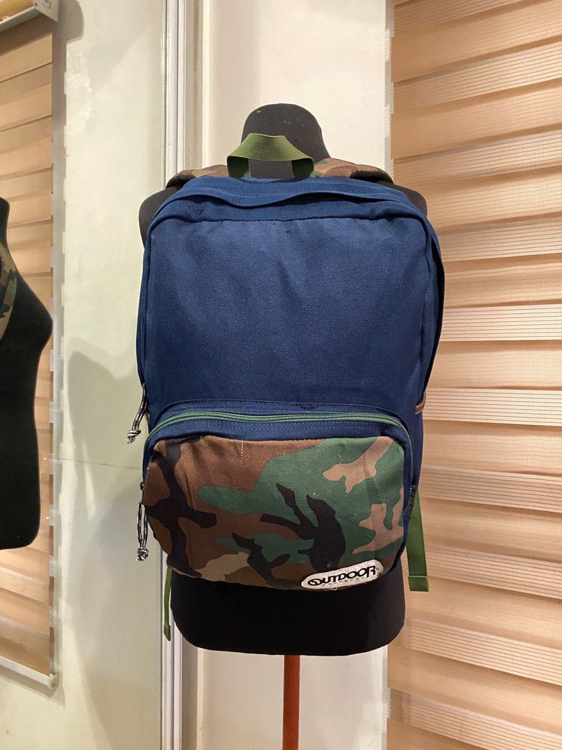 Outdoor Backpack (Category: Backpacks) located in Quezon City. Submitted by prelovedbagsbygiv (Listing ID 1207110285, Image 2). Description: Brand: Outdoor Products Bag type: Backpack Color: blue and camo Material: Nylon Size: Height: 15 in. Length: 11 in. Width: 5 in. In good condition Zipper closure Minimal sign of usage inside .