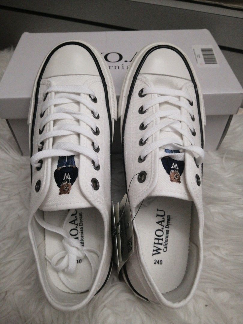 Who. A u bear white shoes with black lines