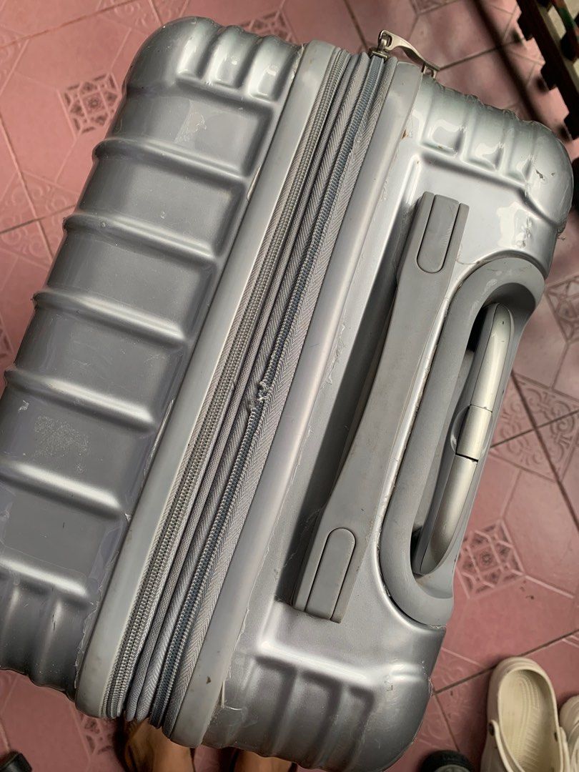 Travel basic luggage in Silver (Category: Luggage) located in Baliuag. Submitted by thrift_stow (Listing ID 1210665108, Image 3). Description: Issue: lot of dents and scratches outside Password is forgotten Damaged zipper Okay pa yung loob niya still usable with compartments No damage inside Handle is working.