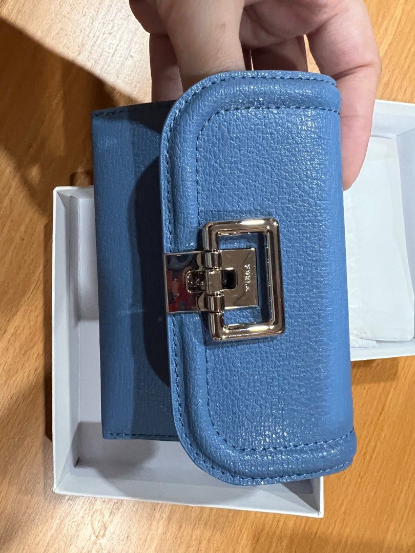 Authentic Furla Cardholder (Category: Luxury Bags & Wallets) located in Cebu City. Submitted by tala10 (Listing ID 1210927520, Image 2). Description: 🌸 SUMMER SALE, @ 4,500 instead of 6k 🌸 This is a brand new, unused Furla cardholder that I personally bought from Furla in New York back in June 2022. Guaranteed authentic. It has a unique clasp design and comes with a pocket at the back for keeping the most needed card accessible. The color is a 