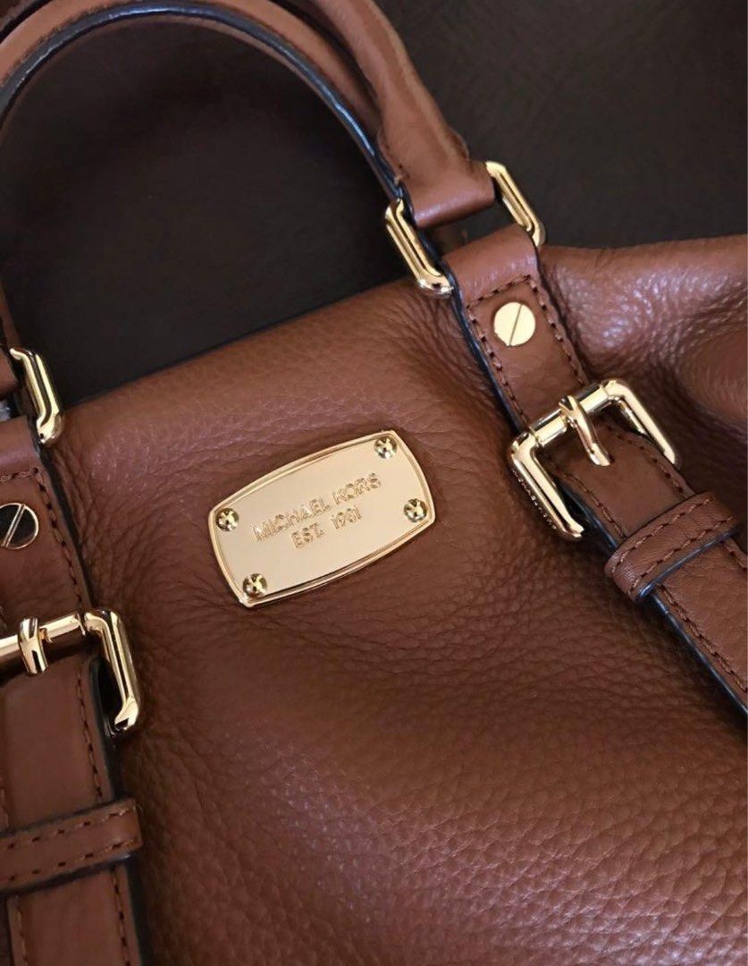 Authentic Michael Kors medium Bedford Leather Satchel Bowling Bag (Category: Luxury Bags & Wallets) located in Dasmarinas. Submitted by __goodbyestuff (Listing ID 1211283423, Image 3). Description: - no dustbag or sling - authentic wala lang receipt, palegit check niyo na lang po - Great for everyday or travel - Excellent condition with no scratches on the leather or the gold hardware. - One exterior pocket on the back, four interior pockets - se