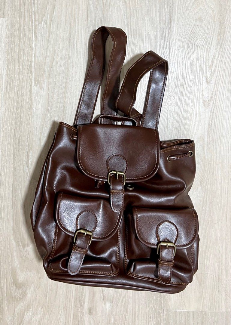 Small backpack (Category: Backpacks) located in Singapore. Submitted by pigami (Listing ID 1211744940, Image 1). Description: Details: •Measurement: 28Lx17W(Base)x29H •Made in Thailand •Soft feel even though PVC, well constructed brown bag (colour is dark brown, more accurate in 2nd pic) •One internal pocket •Brand new in plastic bag Self collect at Postal code 322004.