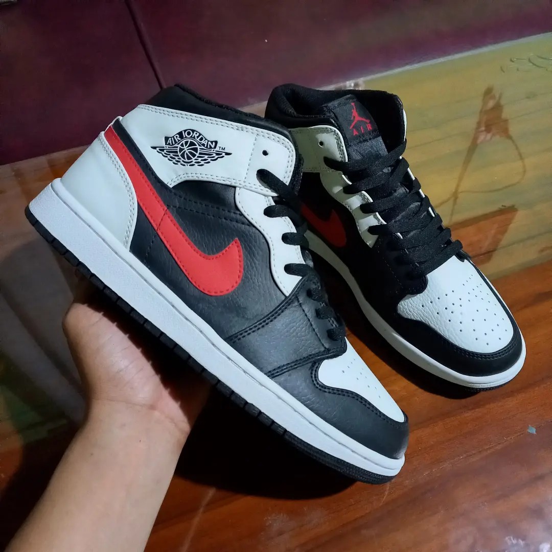 black and white jordans with red tick
