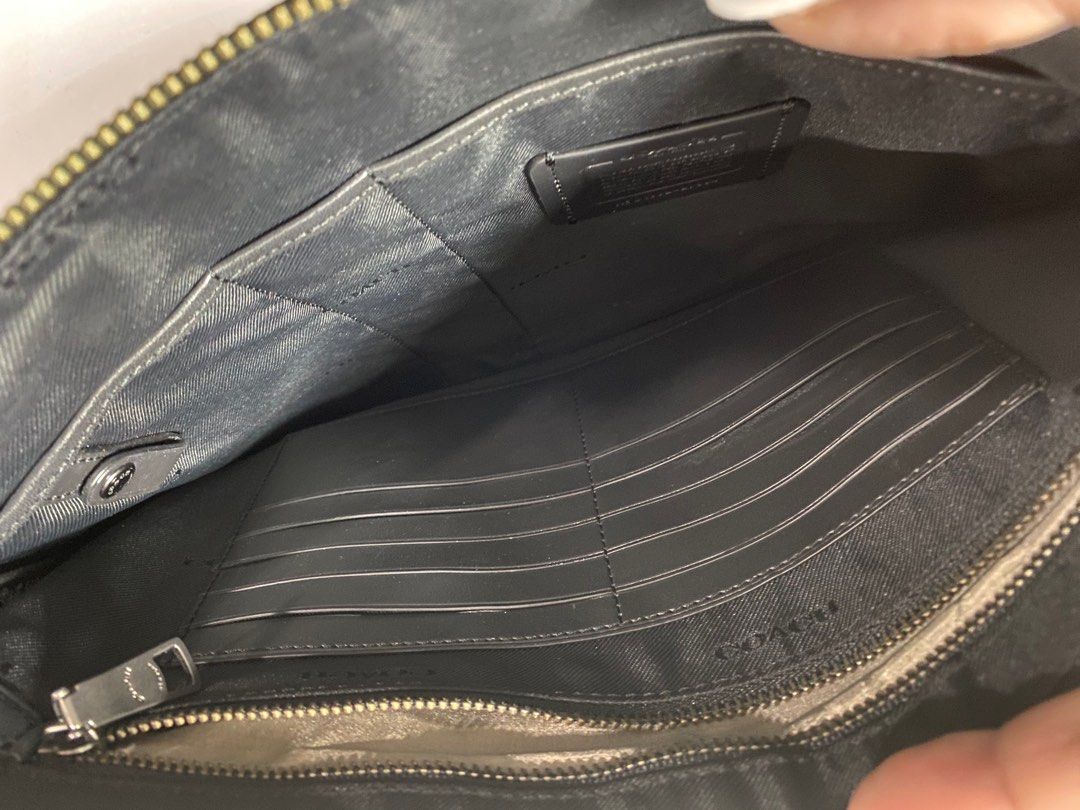 Clutch bag (Category: Luxury Bags & Wallets) located in Pasig City. Submitted by emashopaholic (Listing ID 1207618352, Image 3). Description: Preloved Coach with initials Black leather With inside card pockets Multifunctional pockets No inclusions. As is. Only Php 2999 MoP: Gcash/BDO/BPI.