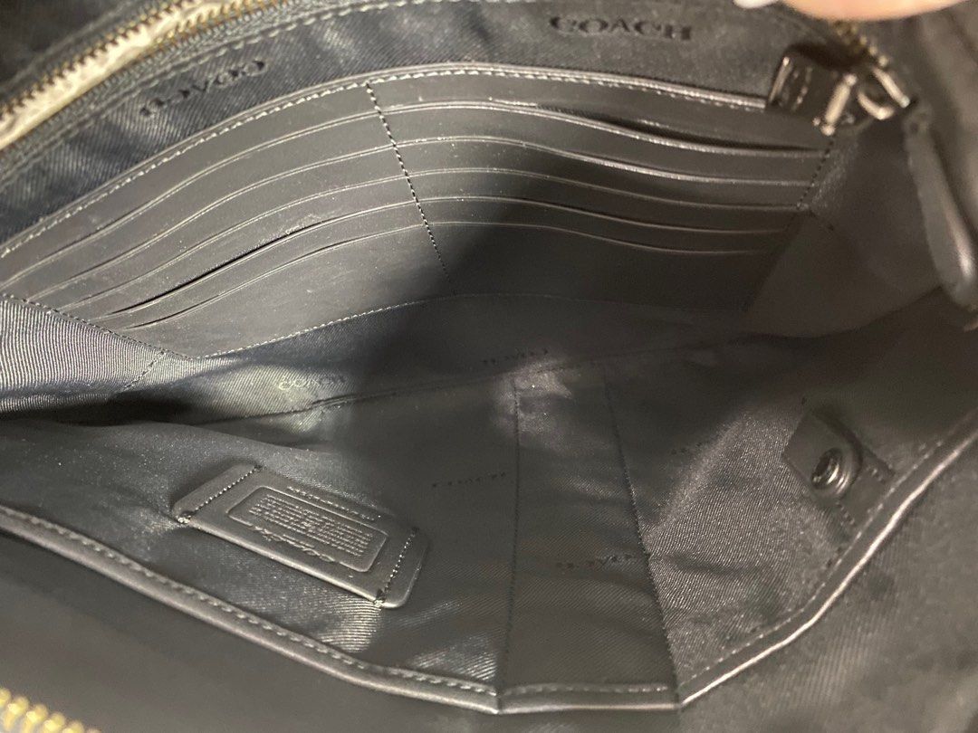 Clutch bag (Category: Luxury Bags & Wallets) located in Pasig City. Submitted by emashopaholic (Listing ID 1207618352, Image 2). Description: Preloved Coach with initials Black leather With inside card pockets Multifunctional pockets No inclusions. As is. Only Php 2999 MoP: Gcash/BDO/BPI.
