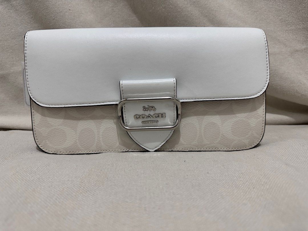 Coach Morgan in Signature Canvas (Category: Luxury Bags & Wallets) located in Santa Rosa. Submitted by Busy_Momma (Listing ID 1257764089, Image 2). Description: Signature coated canvas and smooth leather Inside zip and multifunction pockets Dimensions: 10” x 5.5” Snap closure, fabric lining Detachable handle with 9” drop Outside open pocket Detachable strap with 21 1/4” drop for shoulder or crossbody wear 10 1/2” (L) x 5 1/2” (H) x 2 1/2” (W).