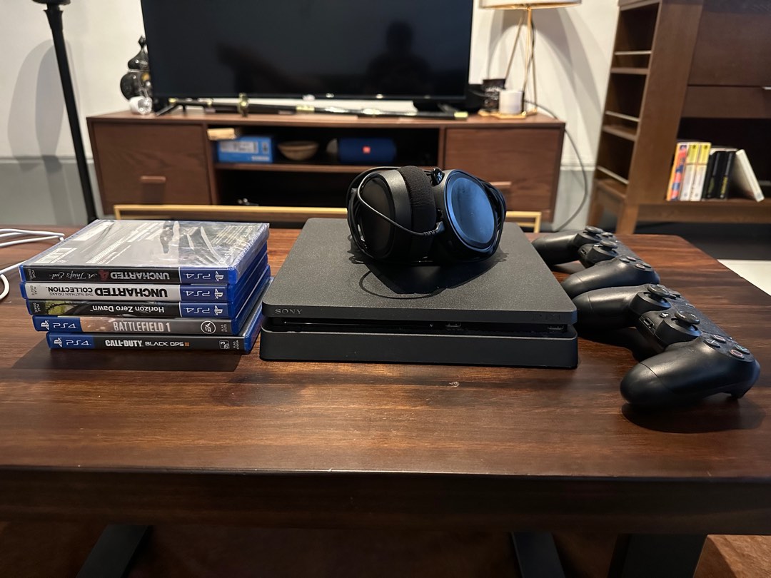 Playstation 4 with 2 controllers 1 gaming headset and 6 games