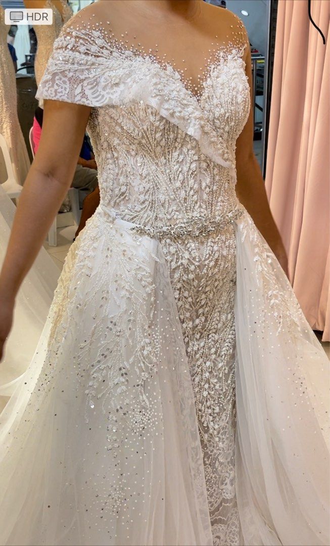 Two-way Asymmetrical Wedding gown for rent (Category: Evening dresses & gowns) located in Makati City. Submitted by cheichic (Listing ID 1208835615, Image 2). Description: Available for rent: message me for details I am selling this as well, message me for the price. Mark Brides Two-Way Asymmetrical Wedding Gown used once last March 2022. This is really beautiful and stunning in person. Half beaded embellished with swarovski. Materials: lace and 