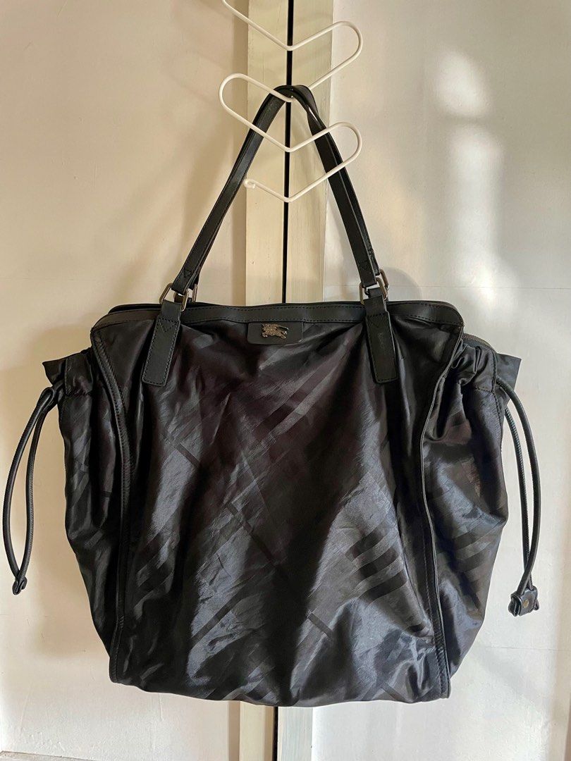 Burberry Bag (Category: Luxury Bags & Wallets) located in Santa Fe. Submitted by sakurabloomshop (Listing ID 1259505034, Image 3). Description: Authentic Burberry Bag with Card only Also good as overnight bag, will fit few clothes, toiletries and laptop Bag size: L16” H19” W7” Made of Nylon Fabric and Leather In good condition Issue: Minor yellow staining on the fabric around the inside pocket zipper Payments via Gcash or BPI Shipping via LBC/JRS