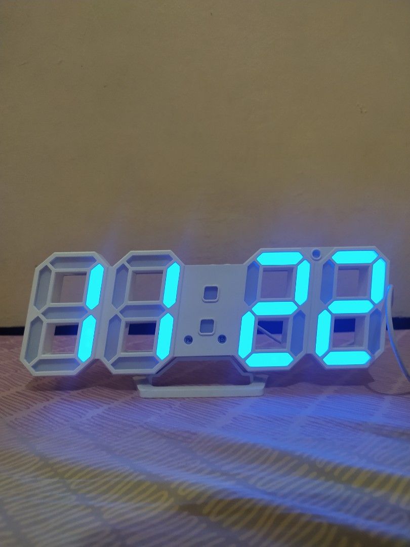 White 3D LED Digital Essential Modern Clock (Category: Clocks) located in Pasig City. Submitted by therainbowcorner (Listing ID 1259511366, Image 1). Description: Can also be hanged on the wall. Features includes: Time Date Alarm Temp length 9" long height 3.6" cord needs cleaning.