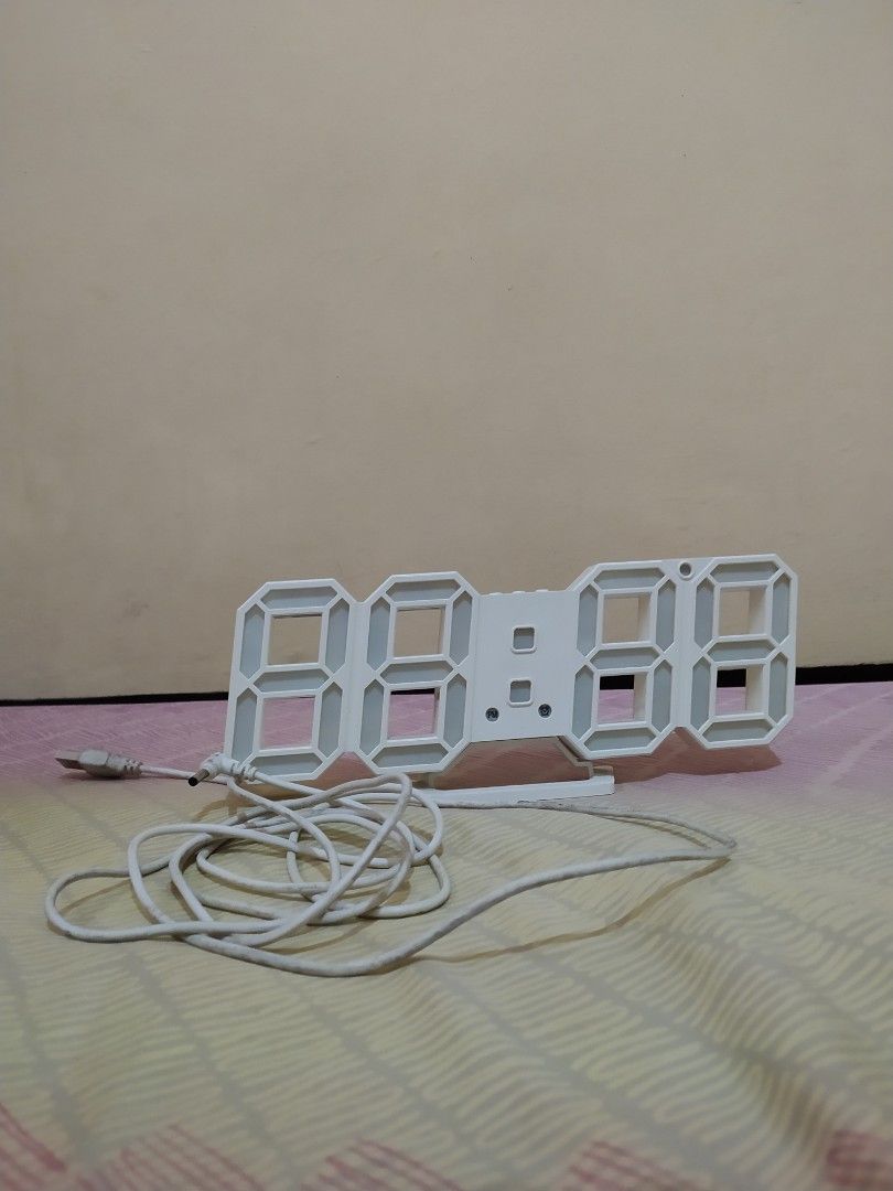 White 3D LED Digital Essential Modern Clock (Category: Clocks) located in Pasig City. Submitted by therainbowcorner (Listing ID 1259511366, Image 3). Description: Can also be hanged on the wall. Features includes: Time Date Alarm Temp length 9" long height 3.6" cord needs cleaning.