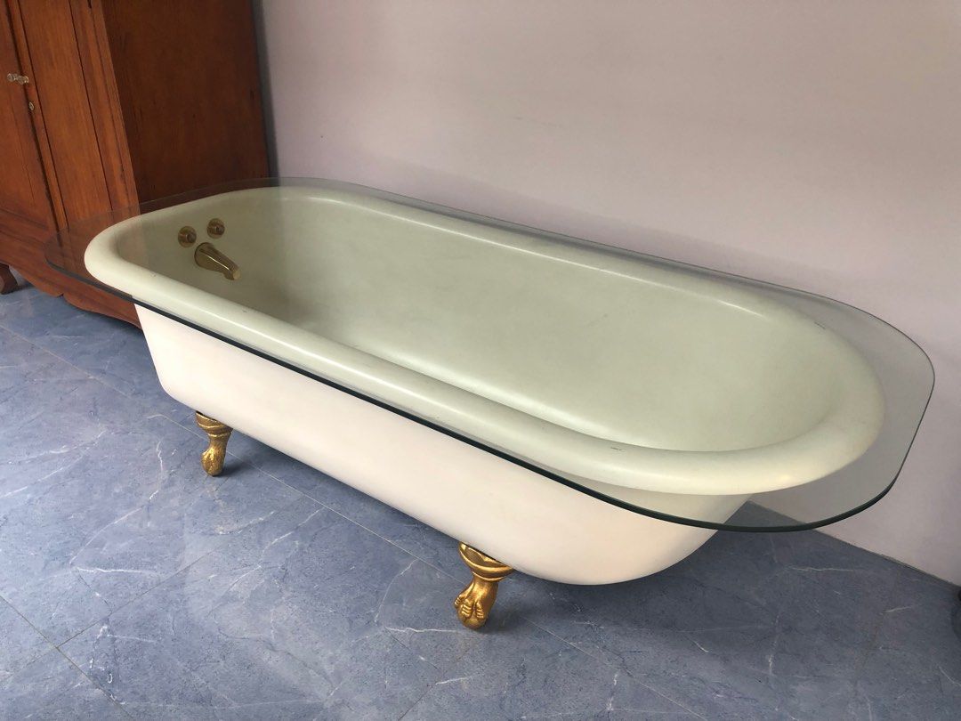 Antique Porcelain Enamel Ware Bathtub (Category: Bathtub & Bath Accessories) located in San Juan City. Submitted by ethannate (Listing ID 1259688710, Image 1). Description: Antique Porcelain Enamel Ware Bathtub - 1930s-40s - with 4 painted gold leaf cast iron foot claw - With oval glass top - With brass faucet Dimensions Length x Width - 66” x 30” inches With glass top - 70” x 33.75” inches Height - 22.25” inches.