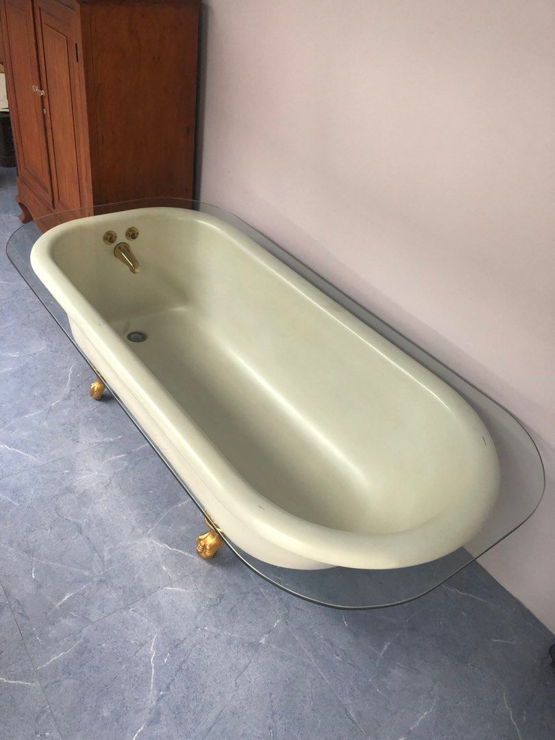 Antique Porcelain Enamel Ware Bathtub (Category: Bathtub & Bath Accessories) located in San Juan City. Submitted by ethannate (Listing ID 1259688710, Image 2). Description: Antique Porcelain Enamel Ware Bathtub - 1930s-40s - with 4 painted gold leaf cast iron foot claw - With oval glass top - With brass faucet Dimensions Length x Width - 66” x 30” inches With glass top - 70” x 33.75” inches Height - 22.25” inches.