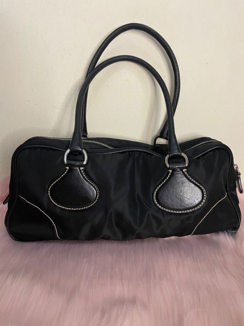 Prada Shoulder Nylon Bag ( Authentic) (Category: Luxury Bags & Wallets) located in Mandaluyong City. Submitted by lalaine_m05 (Listing ID 1259689648, Image 2). Description: Authentic Prada Nylon Bag (Preloved) Rank BC condition Ordered from 2nd hand luxury consignment in Tokyo Japan With original prada dust bag missing na yung authenticity card niya ( I can send more photos for you to authenticate the bag) Handle niya and leather part sa labas me