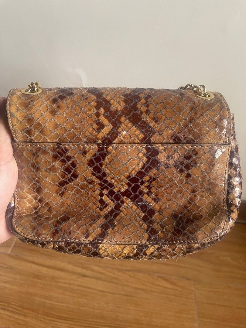 Michael Kors Snake Skin Sling Bag (Category: Luxury Bags & Wallets) located in Manila. Submitted by decluttering03 (Listing ID 1259816770, Image 3). Description: With stains inside the bag but can be hidden. No inclusions. Can be used for casual or evening parties. Can be sling or shoulder bag .