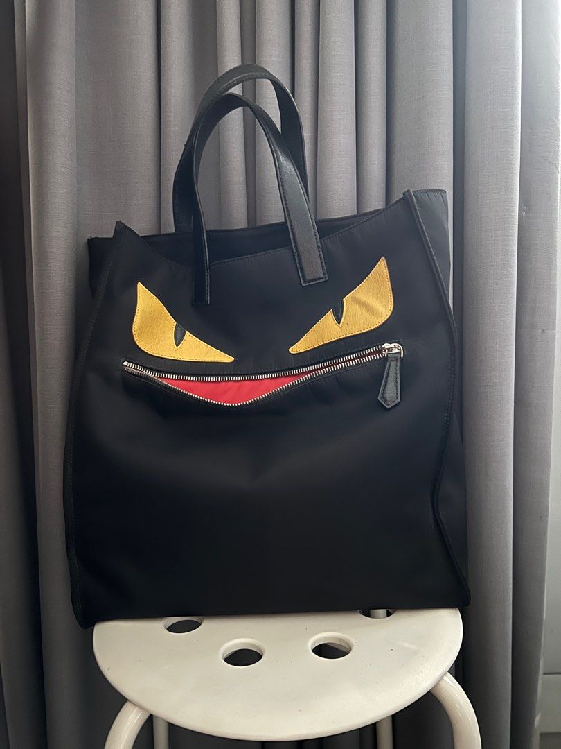 Fendi Monster Shopping Tote (Category: Luxury Bags & Wallets) located in San Juan City. Submitted by thefigtree88 (Listing ID 1260330375, Image 2). Description: Fendi monster shopping tote in black Made of nylon with leather strap Bought in Hongkong Comes with dust bag, care cards and receipt Minor wear shown on the strap and on the left eye (yellow eye tiny color fade) Meet up in Ortigas or greenhills area only .