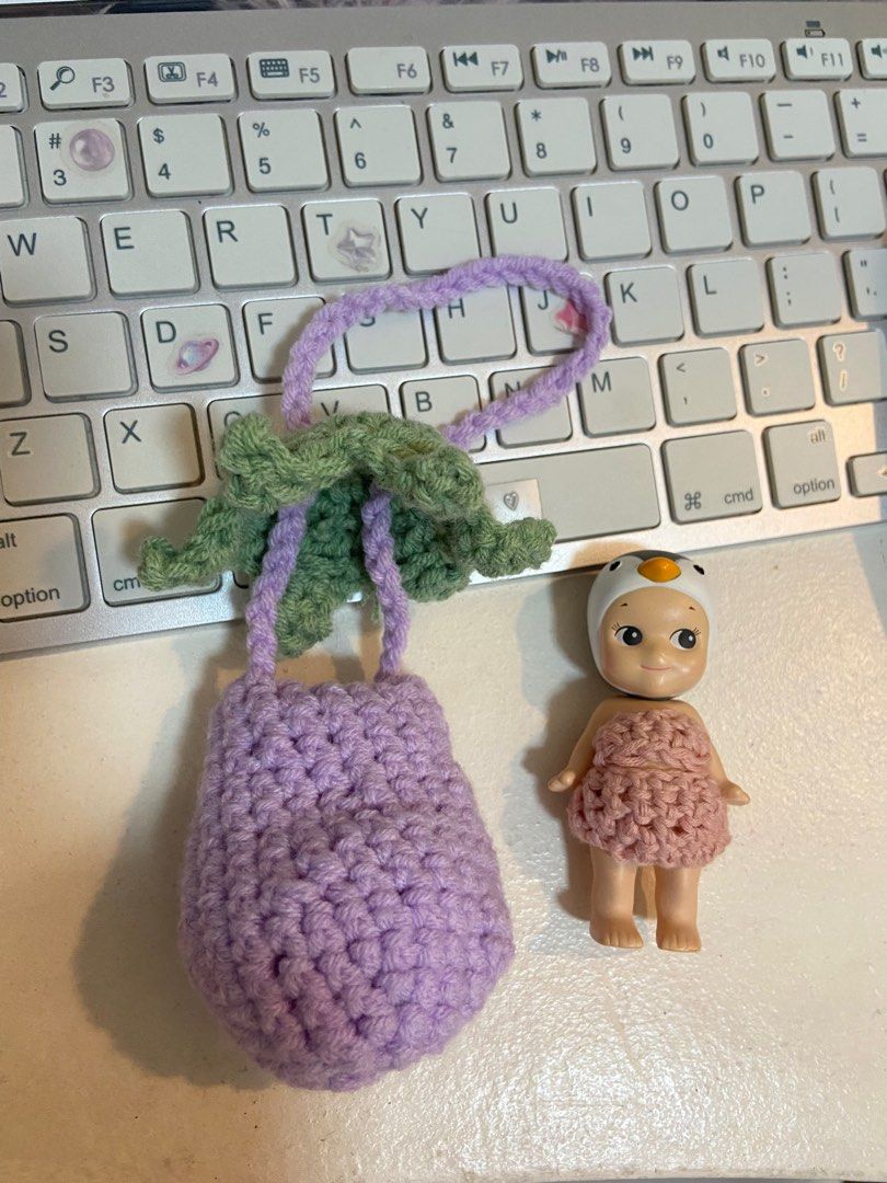 Sonny Angel Eggplant Pouch Bag Charm (Category: Designer & Blind Box Toys) located in Manila. Submitted by polly.studios (Listing ID 1260458479, Image 3). Description: check bio for SHOPEE LINK Guaranteed it won’t fall off your bag given the super secured stem around your sonny angel’s neck ;)) Tried and tested💕 .