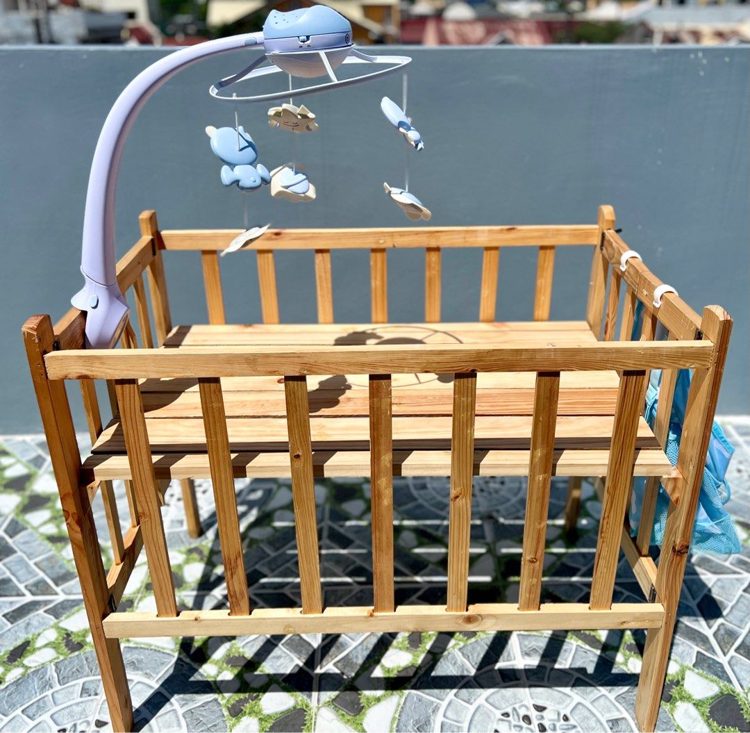 Wooden Crib (Category: Cots & Cribs) located in Paranaque City. Submitted by gastuseraph (Listing ID 1260496617, Image 2). Description: Like new. Wasn’t used as I cosleep with my baby. With infantino crib mobile and hanging caddy organizer 🩷.
