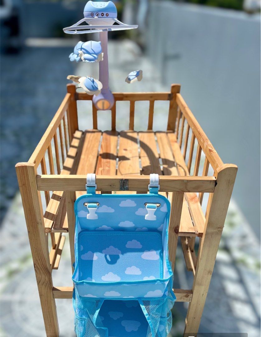 Wooden Crib (Category: Cots & Cribs) located in Paranaque City. Submitted by gastuseraph (Listing ID 1260496617, Image 1). Description: Like new. Wasn’t used as I cosleep with my baby. With infantino crib mobile and hanging caddy organizer 🩷.