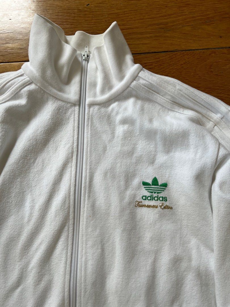 AUTHENTIC TOURNAMENT EDITION WHITE ADIDAS TRACK JACKET ZIP UP (Category: Activewear) located in Manila. Submitted by staceybehag (Listing ID 1260678757, Image 2). Description: Authentic adidas jacket best fits medium man or large woman. The cloth is a bit cotton/ terry cloth ish. .