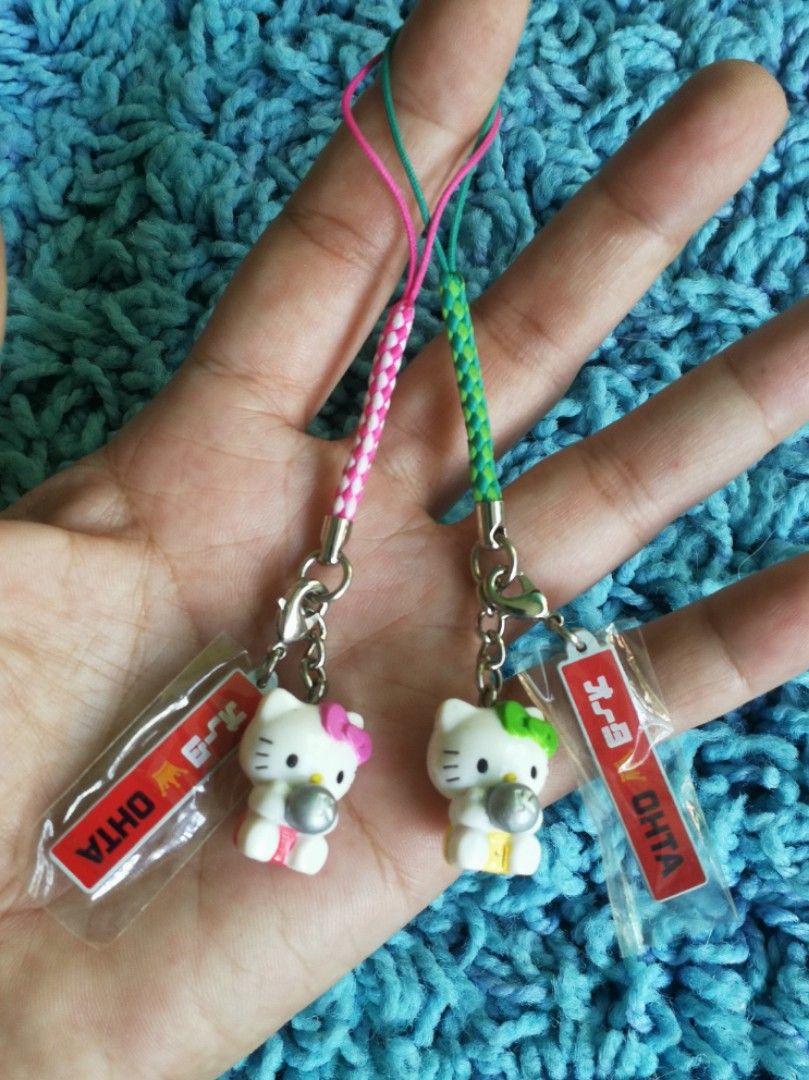 HELLO KITTY Holding Ball Phone Charms (Category: Character Goods) located in Mabalacat. Submitted by whowannashoppe (Listing ID 1260695365, Image 1). Description: P150. 00 (set) or P80.00 EACH HELLO KITTY Holding Ball Phone Charms ©️SANRIO ✔️ Available in two colors ✔️ With markings ✔️ Preloved but in very good condition. ✔️ Unused.