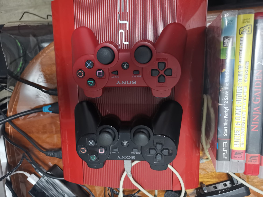Super Slim Red PS3 console with over 30 games included 2 remote ...