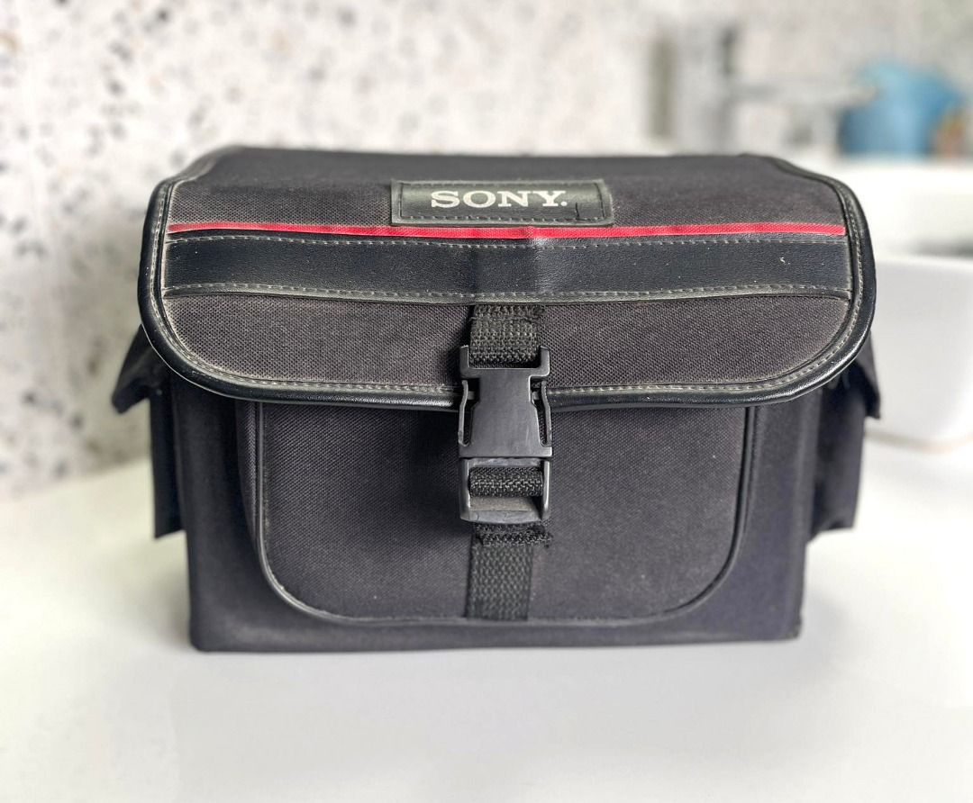 Vintage Sony camera bag (Category: Camera Bags & Carriers) located in Quezon City. Submitted by sustainable.sarah (Listing ID 1261049660, Image 1). Description: Vintage Sony camera bag 8" height x 7" width x 11" length Black color. Has 2 side pockets and 1 front pocket. Complete straps and locks Only flaw is that it's missing a foot, see 6th image. Might need a bit of cleaning as well, but nonetheless, still in mint condition..