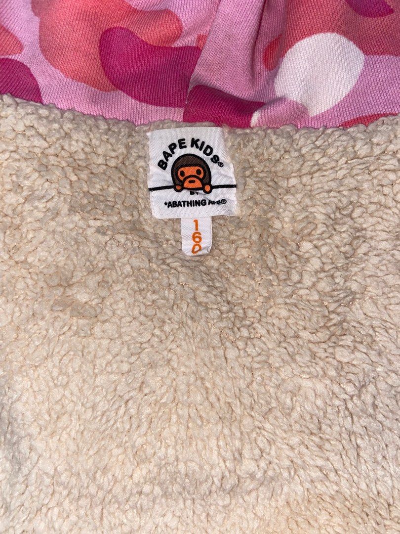 BAPE Pink Camou Hoodie (Category: Coats, Jackets and Outerwear) located in Cavite. Submitted by ginalinettilover1 (Listing ID 1261477218, Image 3). Description: rfs: need funds :) AUTH 💯!!! it’s a kid’s size (160) but it fits small body frames. swipe for ww photos :) 10/10 CONDITION!!! NO FLAWS AT ALL. this hoodie is double lined so it’s really comfy <33.
