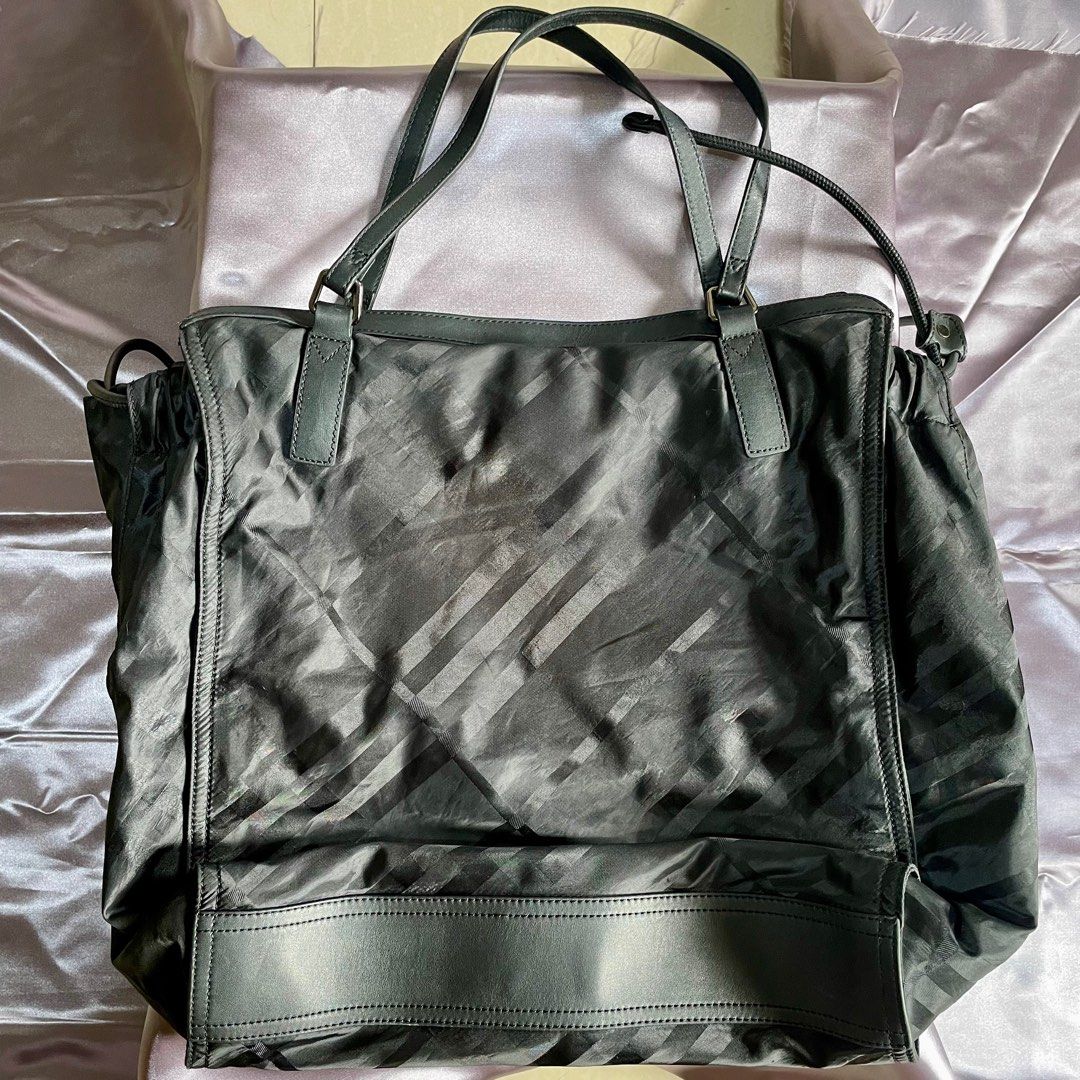 Burberry Bag (Category: Luxury Bags & Wallets) located in Santa Fe. Submitted by sakurabloomshop (Listing ID 1259505034, Image 2). Description: Authentic Burberry Bag with Card only Also good as overnight bag, will fit few clothes, toiletries and laptop Bag size: L16” H19” W7” Made of Nylon Fabric and Leather In good condition Issue: Minor yellow staining on the fabric around the inside pocket zipper Payments via Gcash or BPI Shipping via LBC/JRS