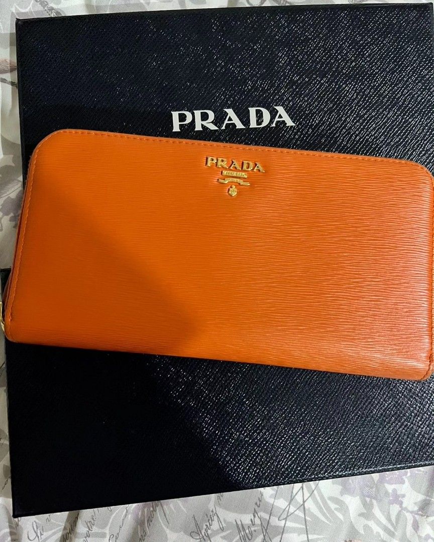 PRADA zip wallet (Category: Luxury Bags & Wallets) located in Quezon City. Submitted by rmseller.2017 (Listing ID 1262100344, Image 1). Description: PRADA zip wallet | vitello move | color: papaya | with box and authenticity card | like new | bought in HK for P28K| P12500 only.